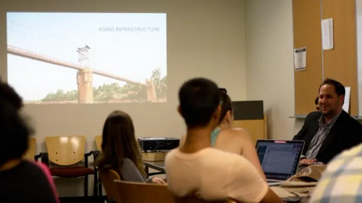 photo of a group of people in a library conference room listening to a speaker